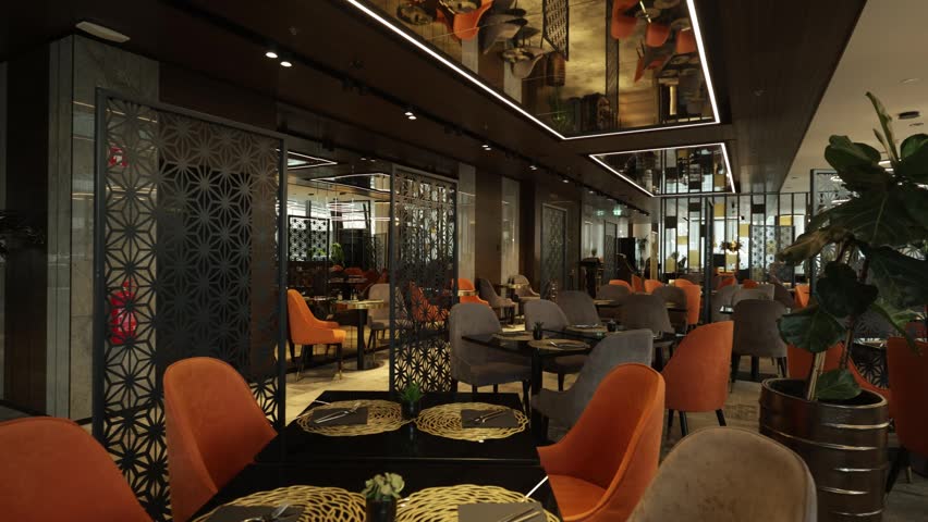 Chic hotel restaurant and lounge area with modern orange chairs