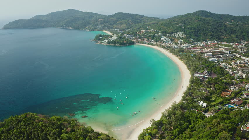 Tropical island landscape, Patong Beach and Phuket town, Thailand. White sand, lush green hills and crystal clear turquoise ocean waters. Perfect for travel and vacation concept. Aerial view panorama