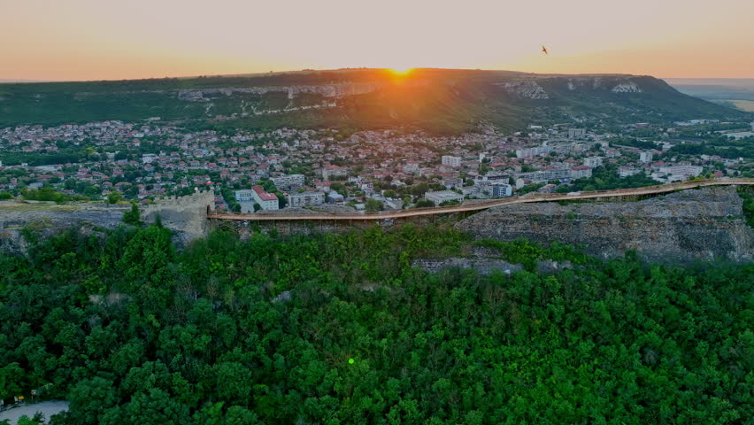 Aerial drone view over medieval fortress Ovech and wooden ancient bridge near Provadia town, Bulgaria during scenic sunset