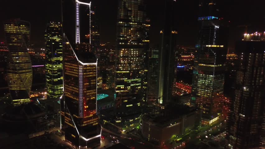 Night drone orbit over Moscow City towers