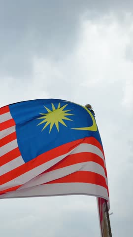 Vertical Close-Up of Malaysian Flag Jalur Gemilang in the Wind