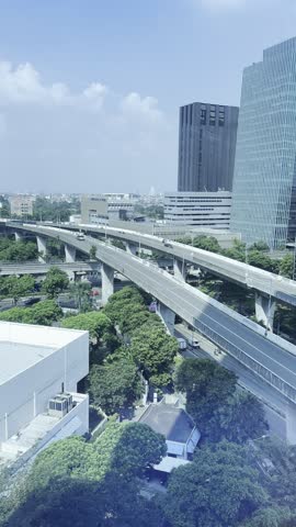 Modern city skyline with elevated roadway and high-rise buildings in Jakarta, representing fast-paced urban lifestyle and contemporary infrastructure development.