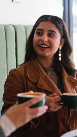 Coffee, drinking and girl friends in cafe with relax, calm or peaceful morning on holiday or break. Scent, smell and women with warm beverage or cappuccino aroma in restaurant or diner on vacation.