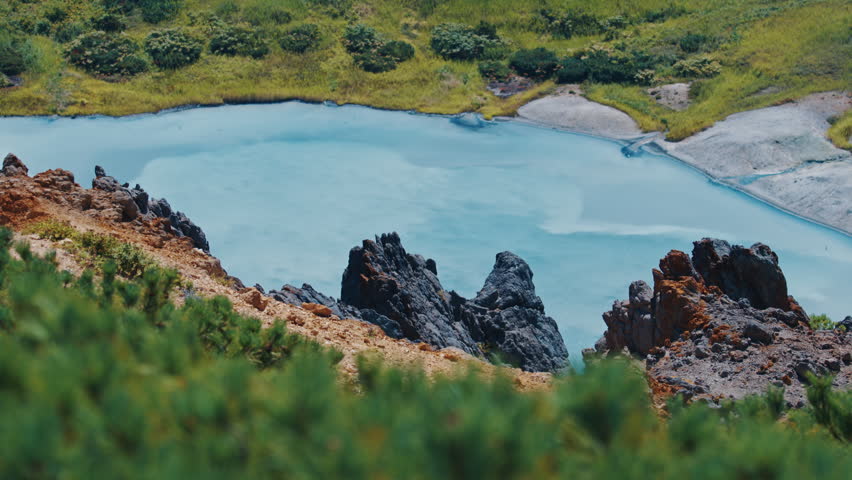 Lake with milky blue boiling water in the active volcanic area of volcano of Golovnin on Kunashir island in Russia