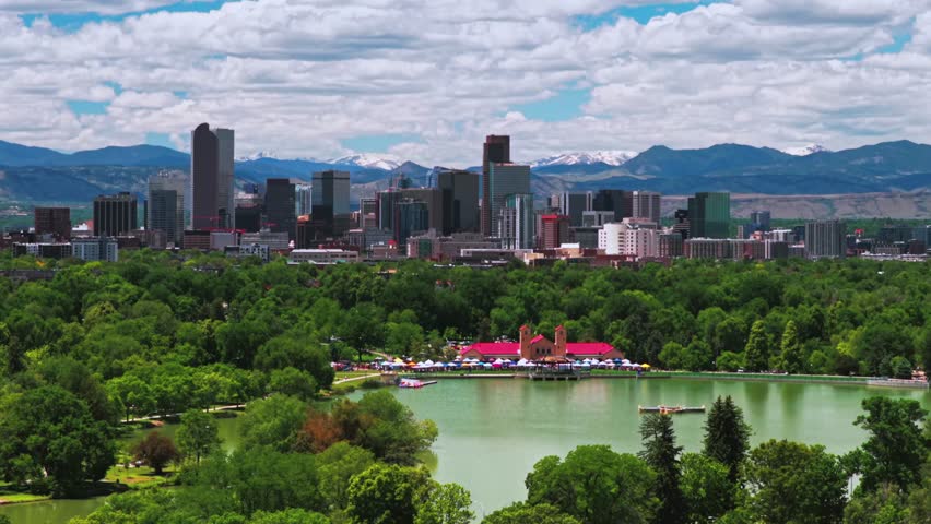 Springtime Denver Pavilions City Park sunny morning blue sky clouds cityscape downtown Denver Mile High skyline Colorado aerial drone Front Range foothills Rocky Mountains Ferril Lake circle right