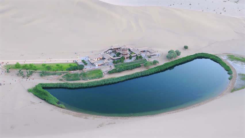 The Singing Sand Dunes and Crescent Lake in Dunhuang, Gansu, China, are a clear spring in the desert that has never dried up or been buried by sandstorms for thousands of years.