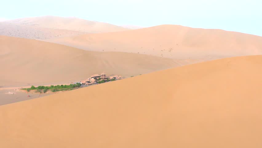 The Singing Sand Dunes and Crescent Lake in Dunhuang, Gansu, China, are a clear spring in the desert that has never dried up or been buried by sandstorms for thousands of years.