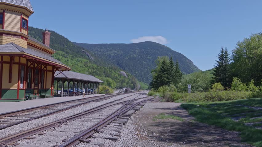 Empty train tracks curving past historic Crawford Notch Station in New Hampshire, USA