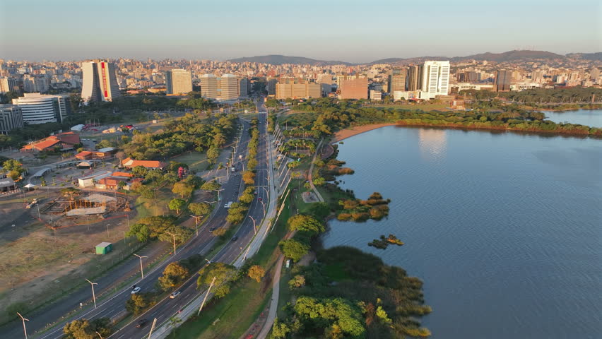 Porto Alegre skyline at sunset light, seen from the lakeside avenue with golden hour warmth