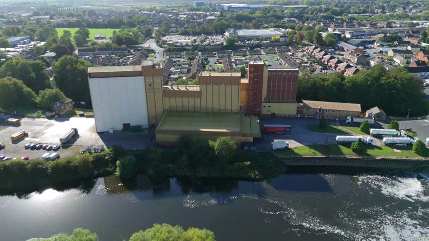Aerial view of a large manufacturing factory on the banks of the River Aire in Knottingley, Yorkshire, UK