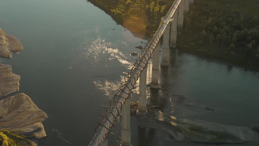 Aerial drone footage of High Trestle Trail Bridge at golden hour over the Des Moines waterway