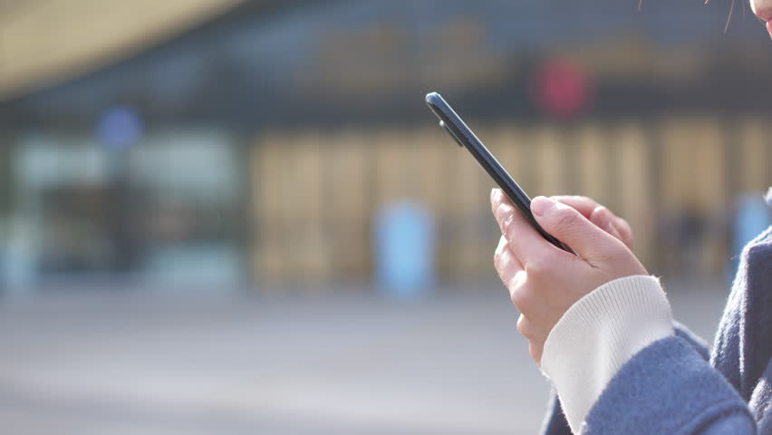 Asian women from East Asia, including China, use their mobile phones to communicate in a shopping mall.