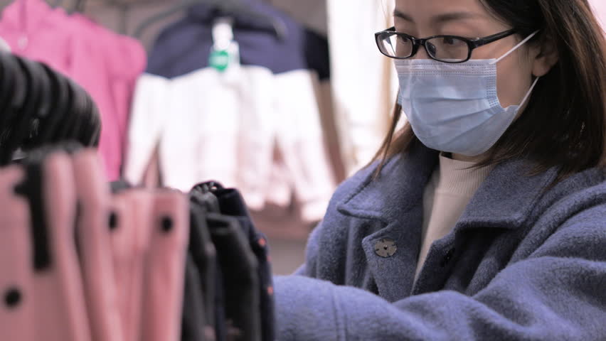 Chinese women shopping for clothes in a mall.