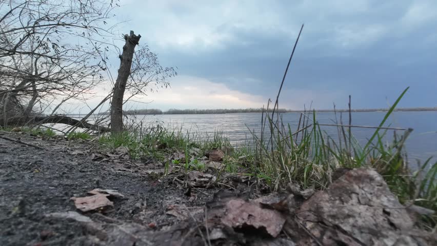 Sunset cloudy sky over the river in the evening of April time lapse