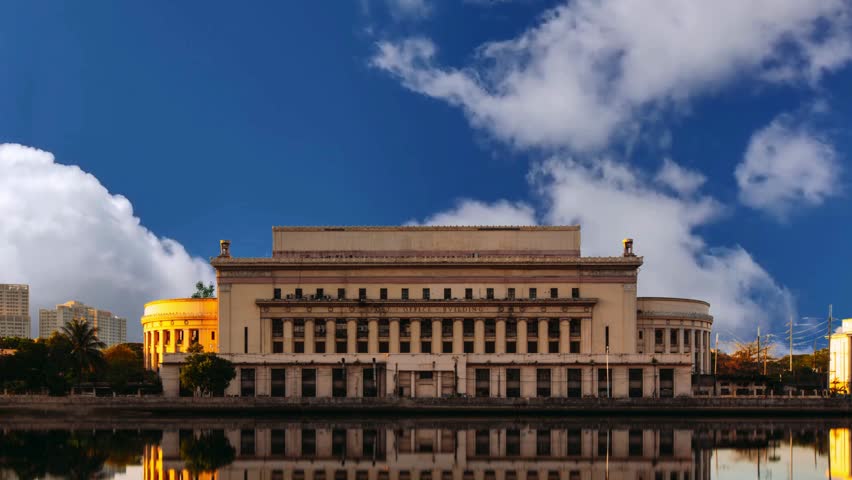 The Manila Central Post Office fronting the Pasig River in the Philippines during sunsetThe Manila Central Post Office fronting the Pasig River in the Philippines during sunset