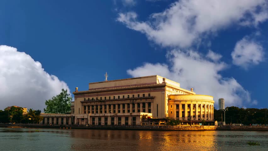 The Manila Central Post Office fronting the Pasig River in the Philippines during sunset