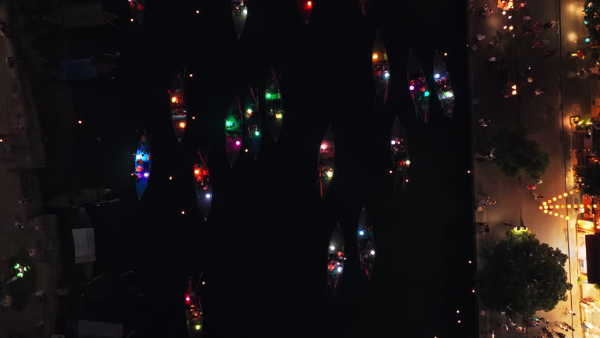 Colorful Lights On Boat Sailing Through Hoai River At Night In Hoi An, Vietnam. - aerial shot