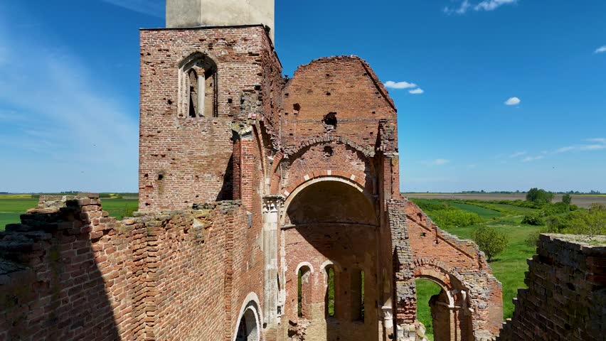 A medieval Catholic church in Arača in the middle of an agricultural field in Serbia.