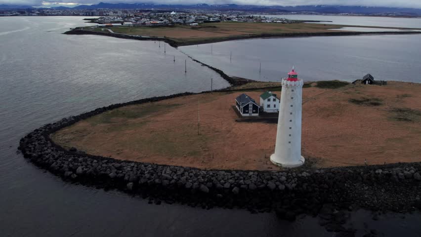 Aerial view of Grotta lighthouse on Seltjarnarnes peninsula near Reykjavik, Iceland, with the city in the background