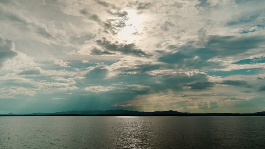 A mesmerizing landscape view of a calm freshwater lake. Cloudy sky. Natural beauty.