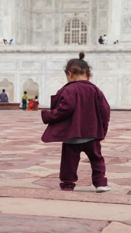 Adorable Child Playing with Rainwater on Stone Pavement Near Taj Mahal Monument