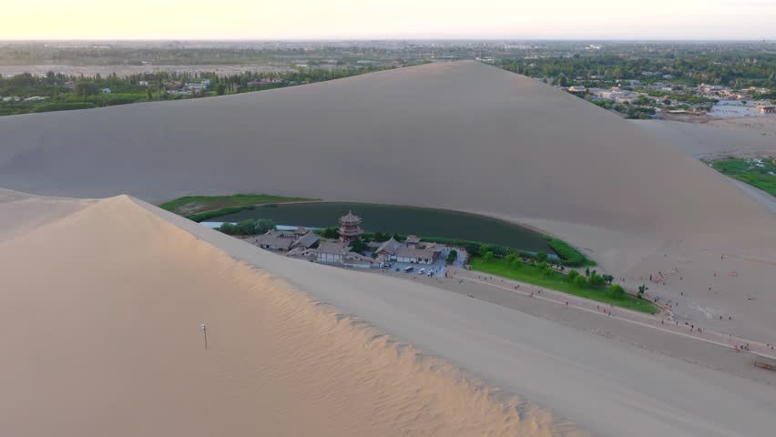 erial Drone Footage of Crescent Moon Spring, Mingsha Mountain Desert Oasis at Sunset, Dunhuang Gansu China
Panoramic Wide Shot of Dunhuang Crescent Lake Surrounded by Giant Sand Dunes, Ancient Chinese