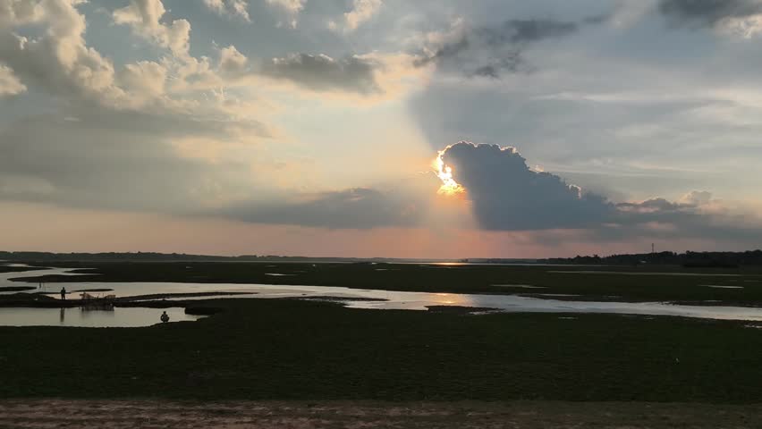 the sun is hiding behind the clouds