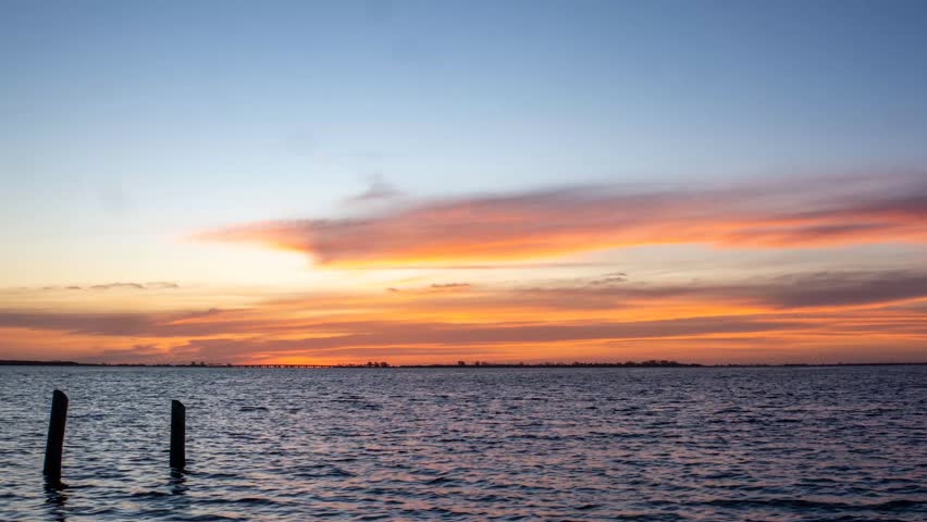 4K Time-lapse of a Vibrant Sunrise and Clouds Over the Ocean at Fort De Soto