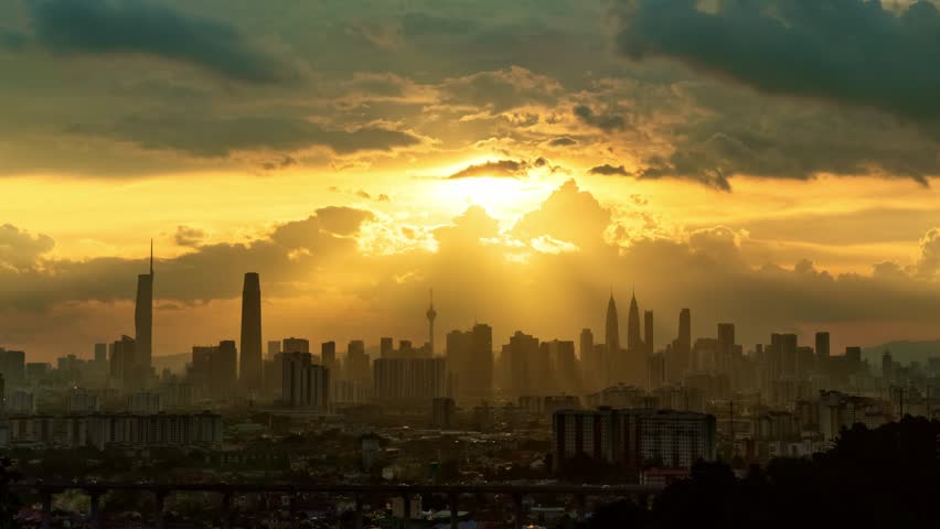 Kuala Lumpur cityscape panoramic view during sunset with dramatic clouds time lapse