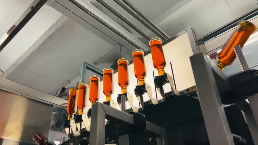 Bottles arriving at quality inspection point on liquor production line
