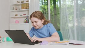 School child studies with laptop at home. Child learns online. Kid types homework. Child uses computer for lesson. Student studies online at home. - Powered by Shutterstock - Get 15% off with code: PIKWIZARD15