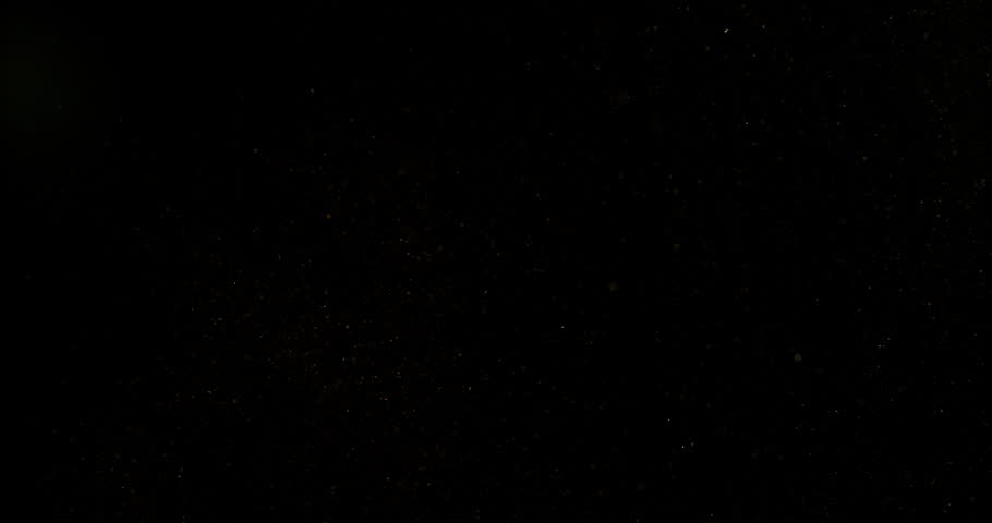 Super slow motion falling snow or dust particles isolated on a black background. Abstract atmospheric SFX overlay with floating debris, cinematic texture and dark visual effect.