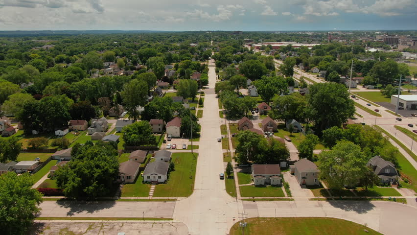 Aerial Forward Establishing Shot of tree-lined residential road and single-family homes stretching toward the horizon in Green Bay, Wisconsin