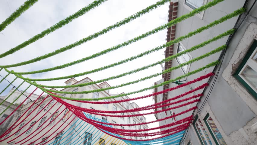 Colorful garlands decorating a narrow street in lisbon, portugal for the festas de lisboa