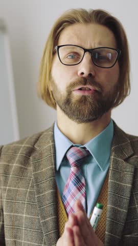 A man talks about learning methods while standing in an office setting.