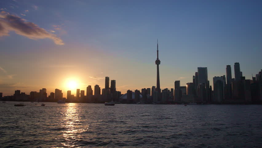 Toronto skyline and CN Tower viewed from a boat on Lake Ontario at sunset, Slow Motion
