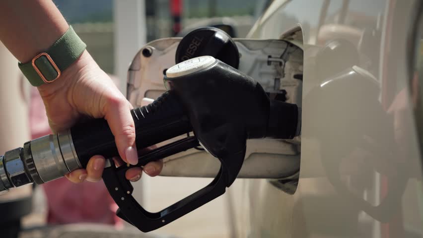 Person refueling a car at a gas station. Fuel prices, energy market and transportation concept. High quality 4k footage