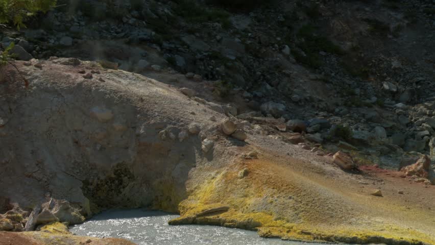 Bubbling mud pot releasing steam from a geothermal vent in Lassen Volcanic National Park