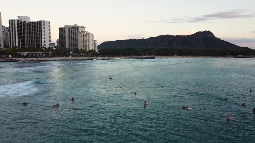 Beautiful aerial view of waikiki beach in honolulu, hawaii. Surfers are waiting for waves with diamond head crater in the background