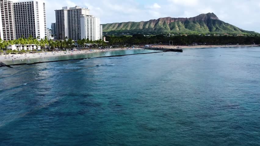 Amazing aerial view of the famous waikiki beach in honolulu, hawaii. Turquoise ocean water with hotels and diamond head crater background