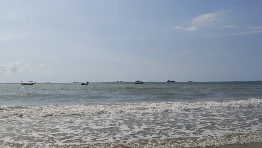 ocean waves rushing towards the sandy beach