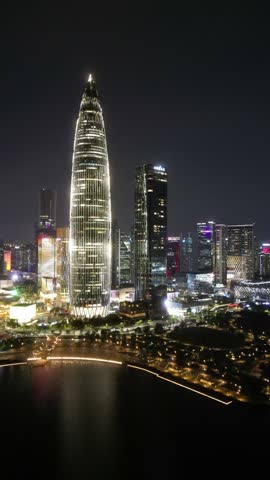 Vertical Aerial Drone View of Shenzhen at night, a major city and Special Economic Zone in Guangdong, China, home to over 443 completed skyscrapers taller than 150 m. Raw Drone Shots.