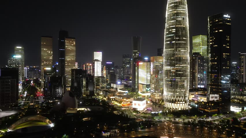 Aerial Drone View of Shenzhen at night, a major city and Special Economic Zone in Guangdong, China, home to over 443 completed skyscrapers taller than 150 m. Raw Drone Shots.