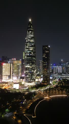 Vertical Aerial Drone View of Shenzhen at night, a major city and Special Economic Zone in Guangdong, China, home to over 443 completed skyscrapers taller than 150 m. Raw Drone Shots.