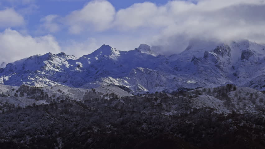 Clouds rolling across snowy mountain peaks in Spain.

Cinematic nature footage featuring dramatic weather conditions in the Picos de Europa mountains.