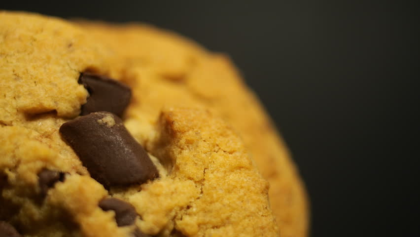 50p macro lens close up side view shot of cookies rotating to reveal texture, crumbs and baked surface details