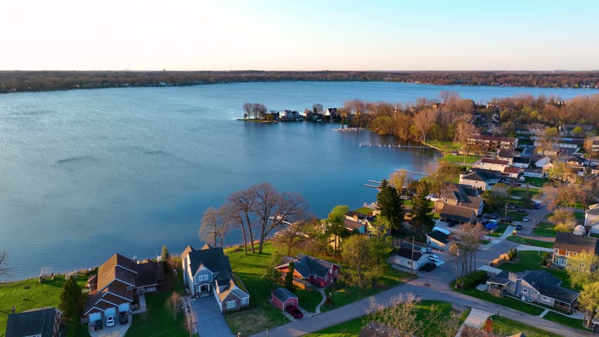 Waterfront residential houses aerial view in the morning on Walled Lake in city of Walled Lake, Michigan MI, USA. 