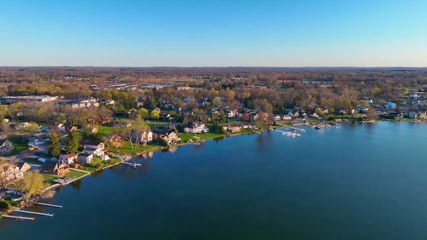 Waterfront residential houses aerial view in the morning on Walled Lake in city of Walled Lake, Michigan MI, USA. 