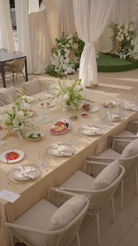Elegant banquet table with floral decoration, prepared for a festive reception. Concept of a restaurant reception.