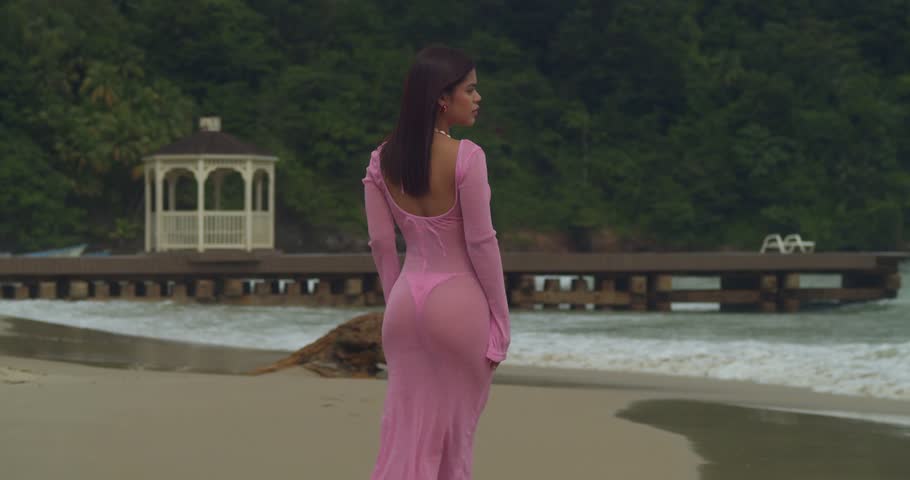 A young woman finds her slice of paradise in swimwear on the golden sands of the North Coast.